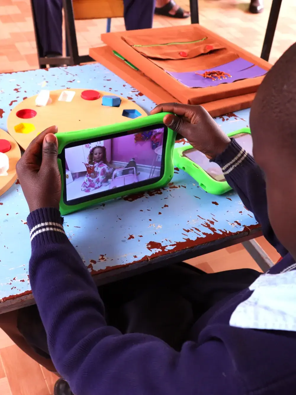 Diverse group of hands joined together in unity over green grass