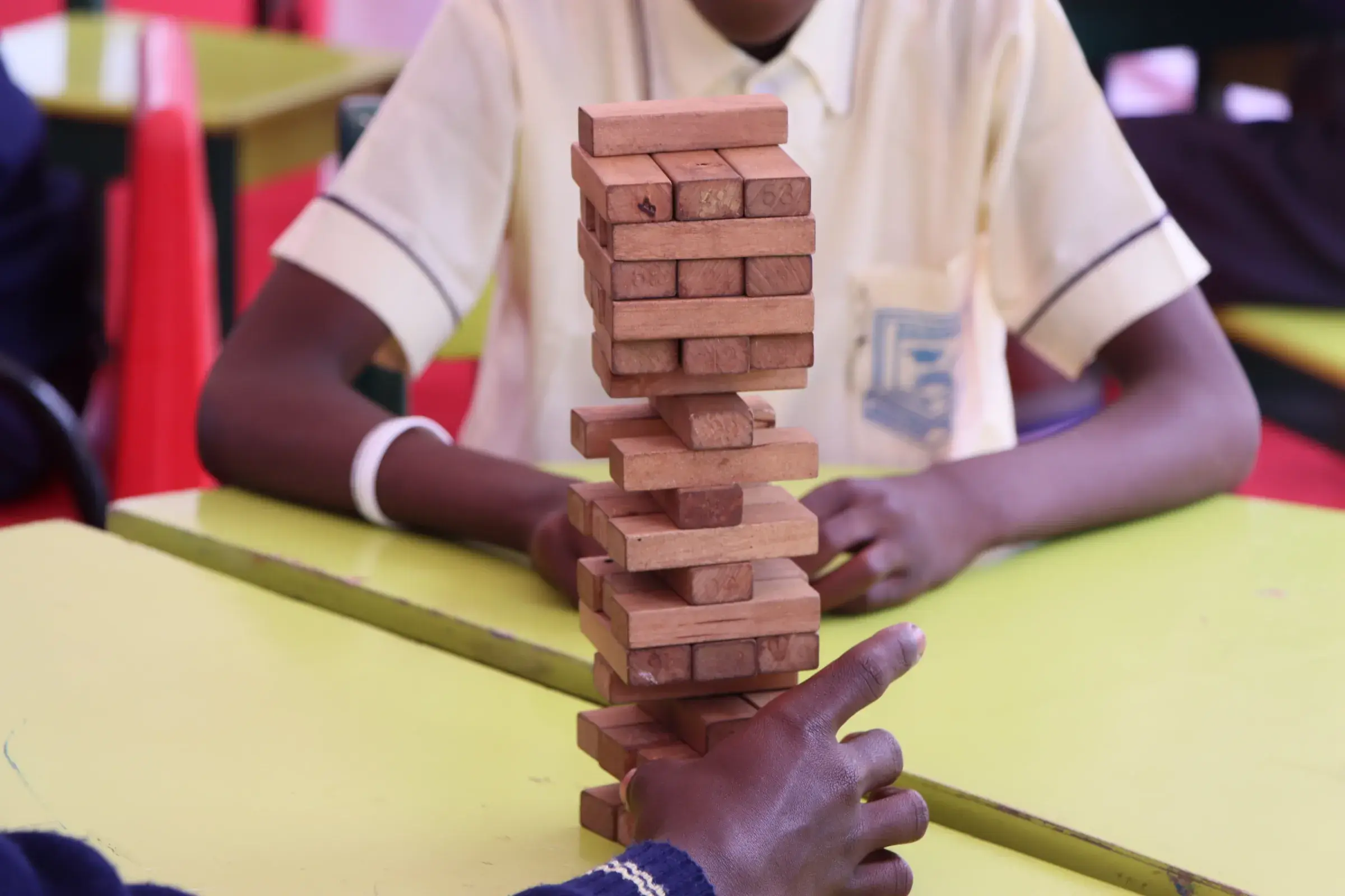 Child stacking wooden blocks