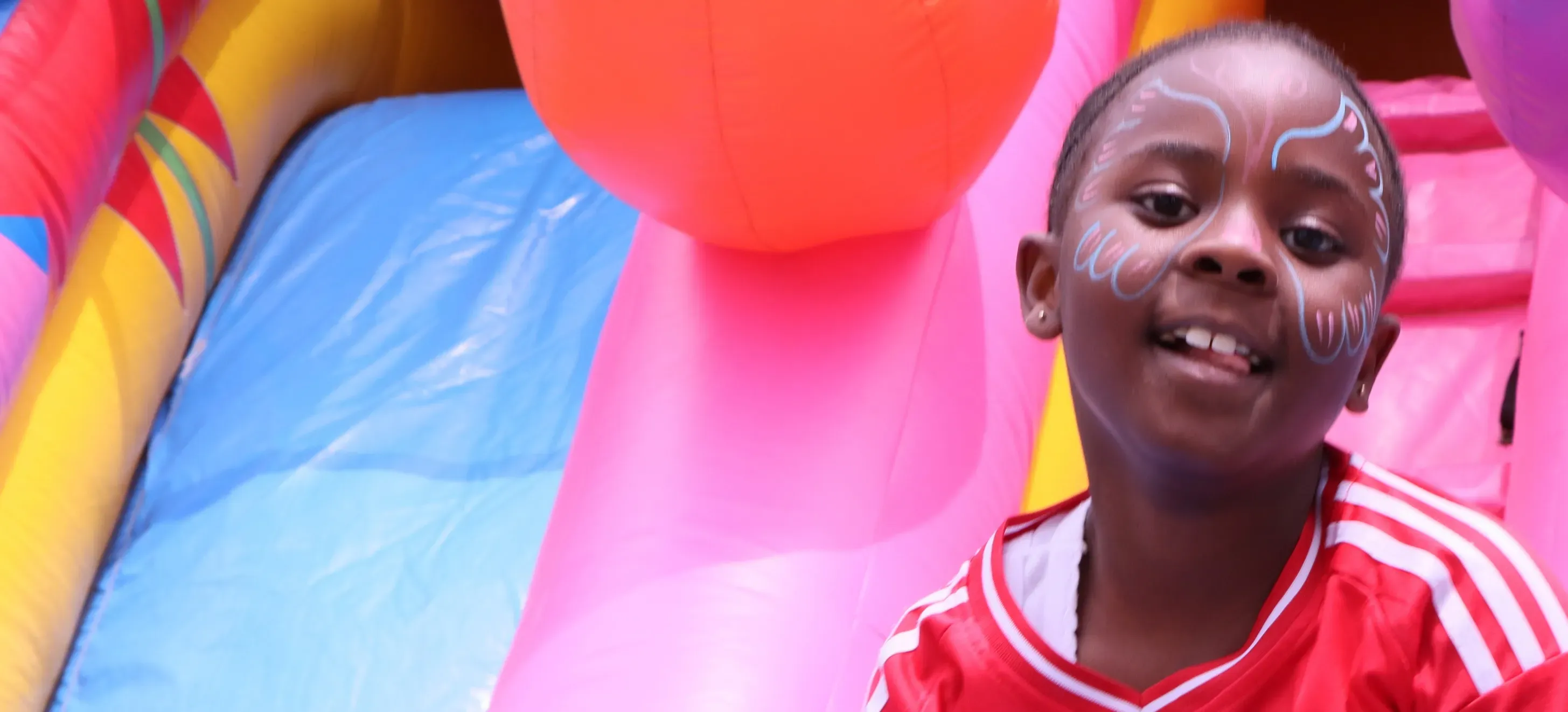 Children playing at a colorful bouncy castle