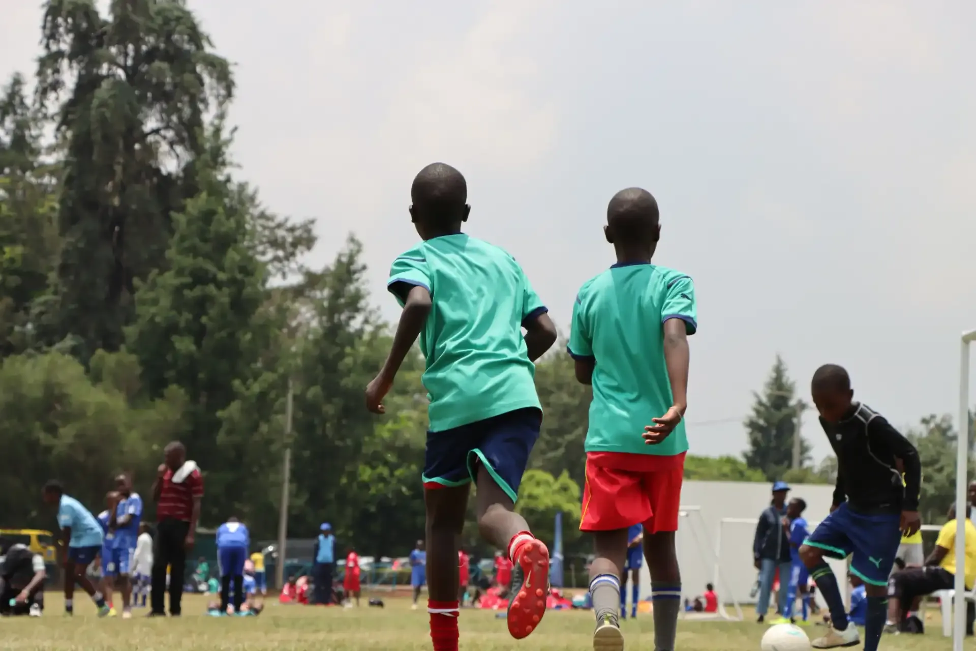 Two children running on a field