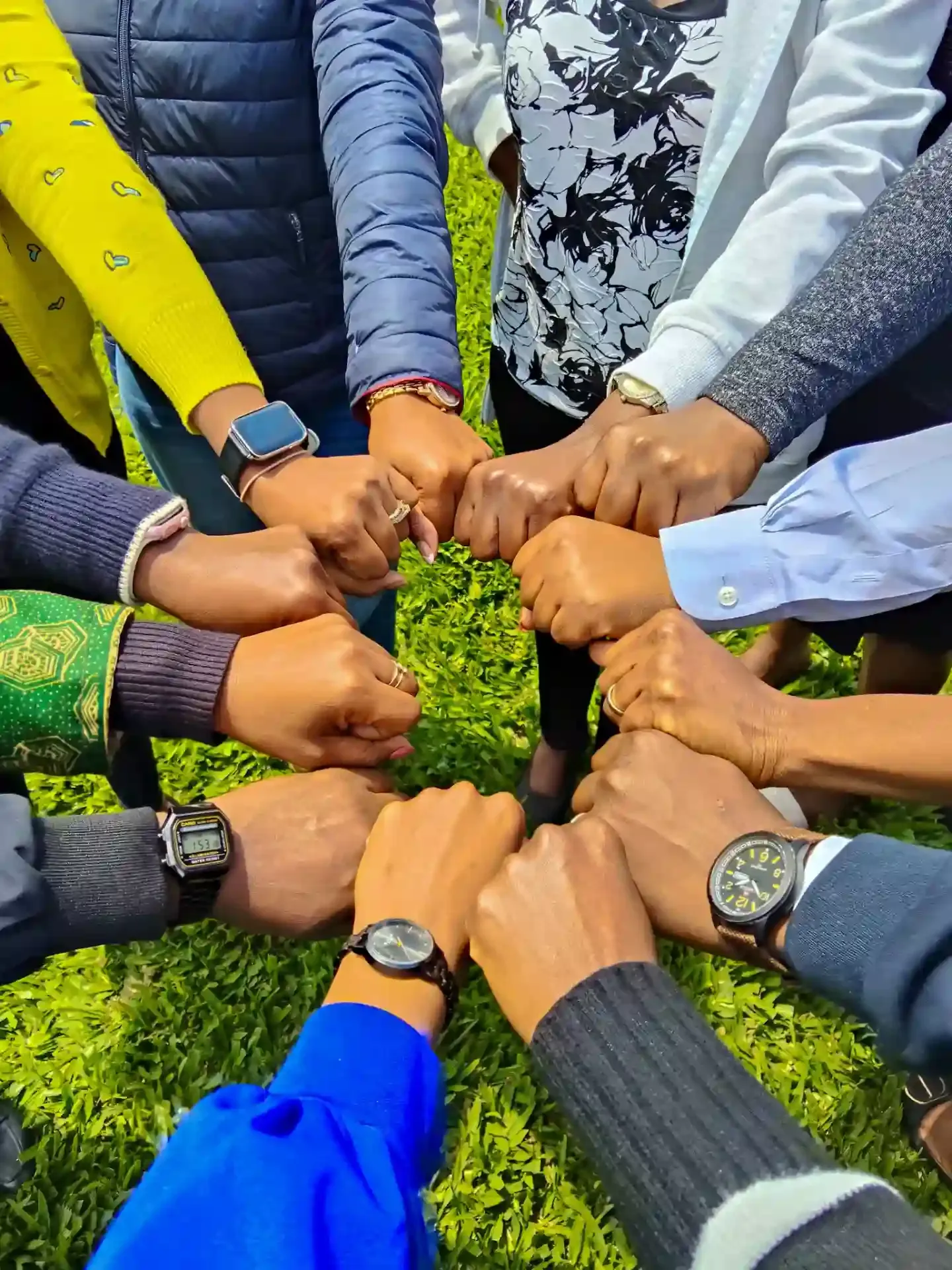 Team members putting fists together in unity